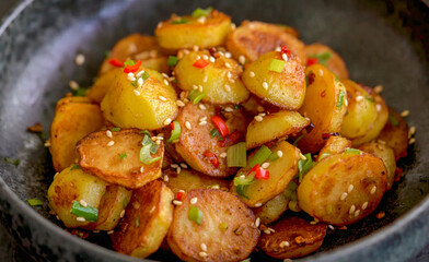 Potato roasted spicy homemade in bowl. Fresh baked crispy potato, serving food for restaurant, Chinese menu, advert or package, close up, selective focus