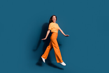 Full body photo of carefree hispanic model jumping wear orange apparel enjoy comfort in new...
