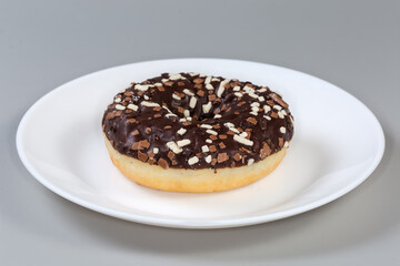 Doughnut with chocolate filling and glaze and sprinkles close-up