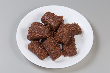 Cookies with rice balls and milk chocolate coating on dish
