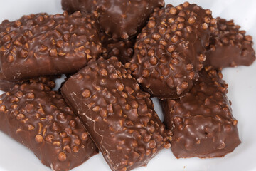 Cookies with rice balls and milk chocolate coating close-up