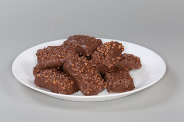 Cookies with rice balls and milk chocolate coating on dish