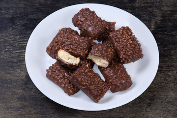 Cookies with rice balls and milk chocolate coating on dish