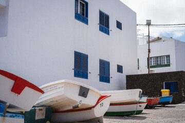 Typical white house with blue windows in the village of Arrieta with boats. Lanzarote, Canary Islands, Spain