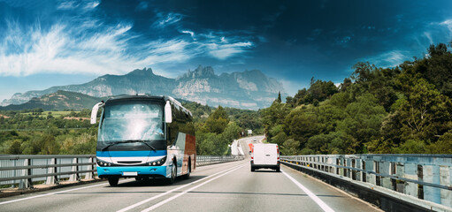 Spain. Touristic Bus Car Goes On Motorway Freeway Highway Road On Background Of Spanish Montserrat Mountain Nature Landscape.