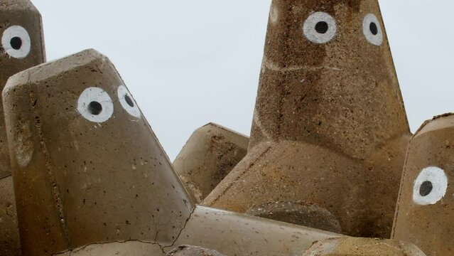 Close up of tetrapods on Sylt, a German island. Street artists put eyes on them and turned them into faces