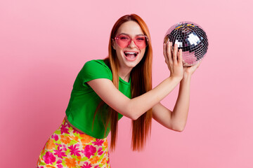 Photo of gorgeous woman with ginger hairdo dressed green t-shirt in sunglass throwing bisco ball...