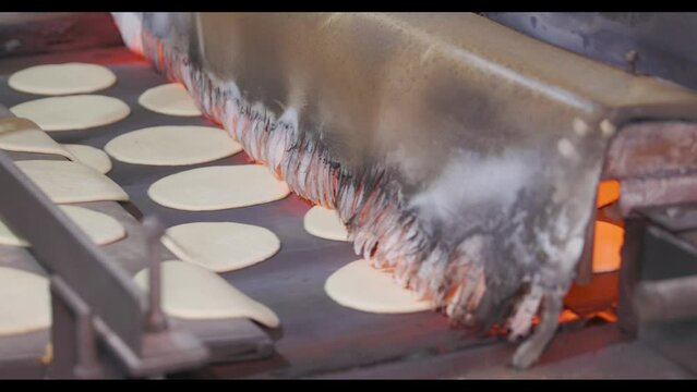 Automatic bakery production line The oven in the bakery. Automatic bread  - pitas production line