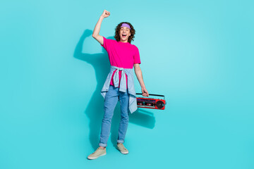 Full body photo of young teenager hipster guy loves old style objects holding boombox wearing headband isolated on cyan color background
