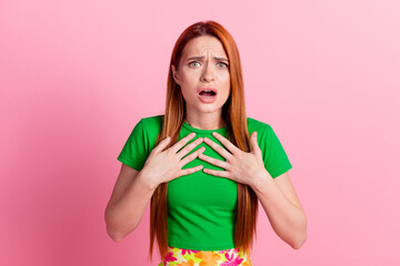 Photo of offended woman with ginger hair dressed green t-shirt hold arms on chest staring open mouth isolated on pink color background