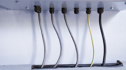 Wiring power input output with cable glands protection on the electric  panel control. Cable...