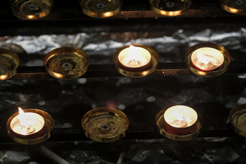 Close-up of church candles on display stand