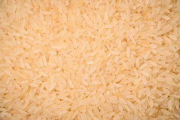 Large grains of uncooked white rice in a ceramic bowl