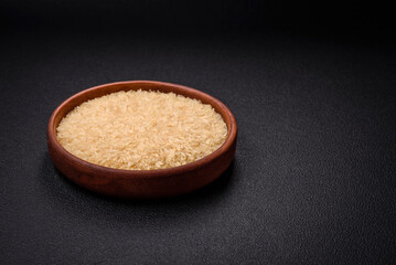 Large grains of uncooked white rice in a ceramic bowl