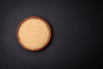Large grains of uncooked white rice in a ceramic bowl