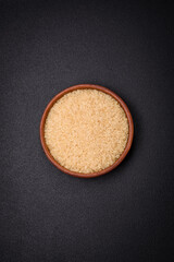 Large grains of uncooked white rice in a ceramic bowl