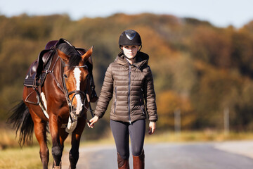 Girl rider goes riding with her horse ready to ride.