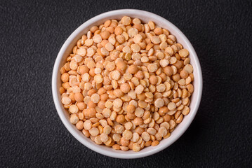 Dried pea grains, divided into halves, are yellow in color when raw