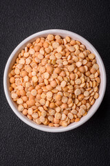 Dried pea grains, divided into halves, are yellow in color when raw