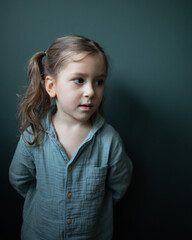 Little cute girl near green background