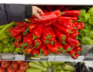 choosing peppers at the grocery store