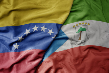 big waving national colorful flag of equatorial guinea and national flag of venezuela . macro