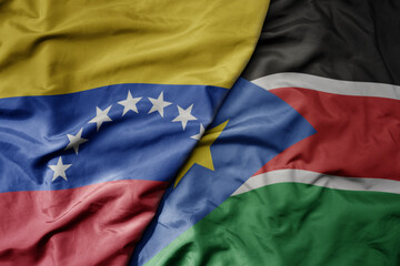 Fototapeta premium big waving national colorful flag of south sudan and national flag of venezuela . macro