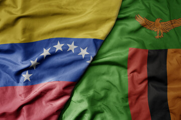 big waving national colorful flag of zambia and national flag of venezuela . macro