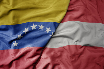 big waving national colorful flag of austria and national flag of venezuela . macro