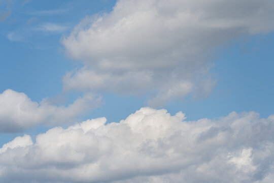 Photo texture of blue sky with cumulus clouds, close-up photo.