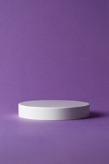 White minimal podium for product display on purple background.