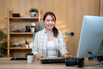 Female video editor works indoors in creative office studio. - 726435404