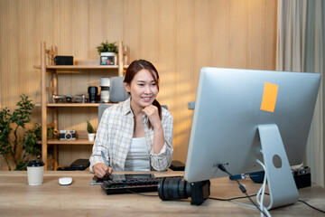 Female video editor works indoors in creative office studio. - 726435445