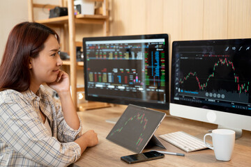 Side view businesswoman analyzing stock market investment with digital tablet.