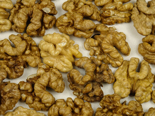 Walnut fruits, peeled from shell and husk. Healthy food. Edible nut seed, background