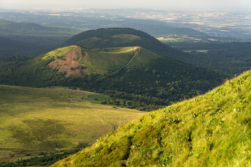 Obraz premium Auvergne vulcan since top of the Puy de Dome vulcan at sunset. Dramatic light landscape. Clermont Ferrand, France.