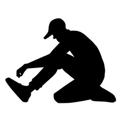 silhouette of a person tying shoes