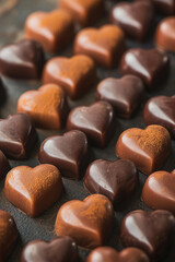 Fototapeta premium Chocolate candies in the shape of a heart. Valentine's Day. Generative AI