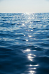 Tranquil sea with glistening sun reflection natural background