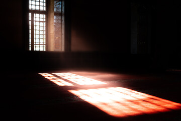 Islamic background photo. Interior of a mosque illuminated by sunlight