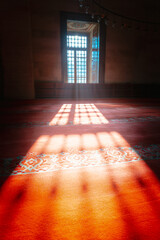 Islamic concept. Sunlight coming through from the window of a mosque with haze.