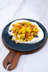 Baked cauliflower and vegetables served on a large plate