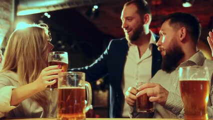 Log awaited meeting. Group of smiling happy friends sitting at pub, drinking lager foamy beer, laughing and spending good relaxing time. Concept of leisure time, friendship, fun, youth, enjoyment