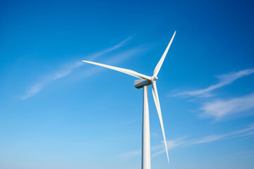 Fototapeta premium Wind mill turbine in front of blue sky