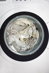 Drum of the washing machine with laundry inside.