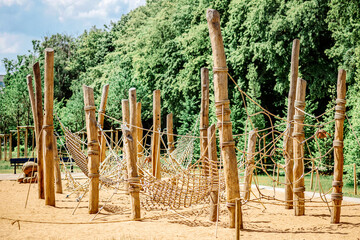 Children Playground Equipment with Wooden Logs Beams Net Swing. Modern Urban Wooden  Climbing Play Area for Activity Kids in Park.