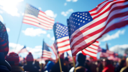 Rally in the square with American flags against the sky, blurred background, many people in square, blue clear sky with clouds, the importance and responsibility of participating in state elections