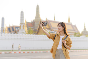 Traveler asian woman in her 30s explores the Grand Palace with a local guide. Uncover hidden gems...