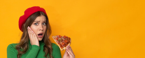 Beautiful young woman with pizza on isolated orange background.