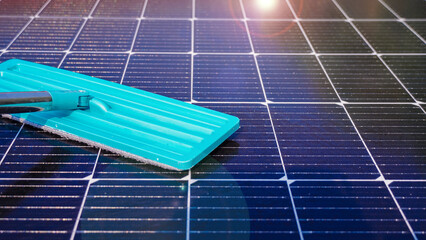 Cleaning solar panels with mop to improve the efficiency of solar energy storage.Solar cell...